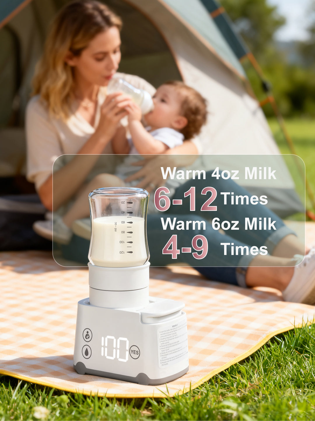 Portable milk warmer on a grassy outdoor setting with a woman and child in the background.