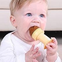 Baby boy holding and chewing Smily Mia chocolate ice cream silicone teether toy for teething relief
